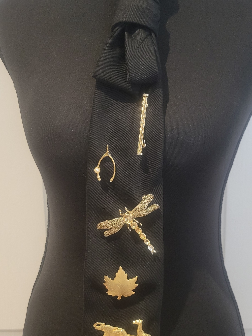 Black Tie Adored with Multiple Gold Brooches and Pins